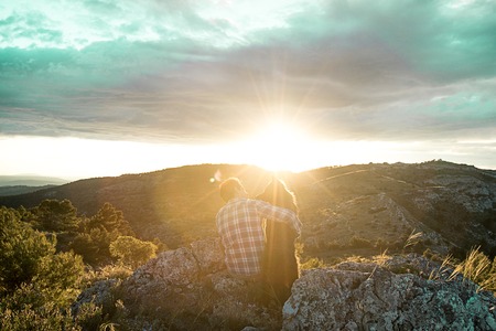 Man at sunset hugging his dog. Concept of love between dog and manの写真素材