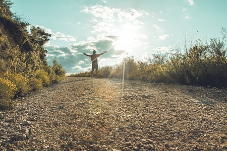 Guy hiking in the mountains. Man walking on the mountainの写真素材