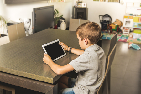 Child watching a tablet at home. Concept technologyの写真素材