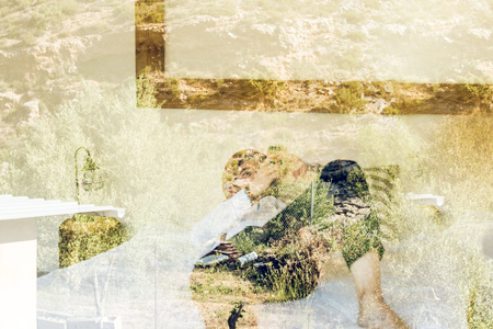 Man looking at his cell phone through a window in his house. Guy looking at the cell phone.の写真素材