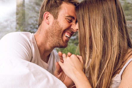 Close-up of a boy and girl couple looking at each other and laughing. Concept of love between couplesの写真素材