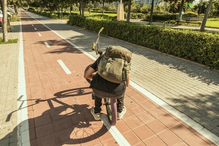 Boy with a bmx around town. Concept of urban street sportsの写真素材