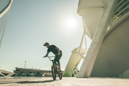 Guy riding a bmx bike in the city Concept of street sports for young peopleの写真素材