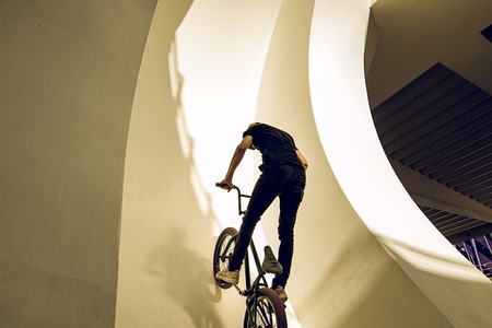 Guy riding a bmx bike on the street. Freestyle BMX in the city, extreme sports concept