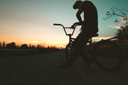 Silhouette of a guy with a bmx bicycle. BMX riderの写真素材