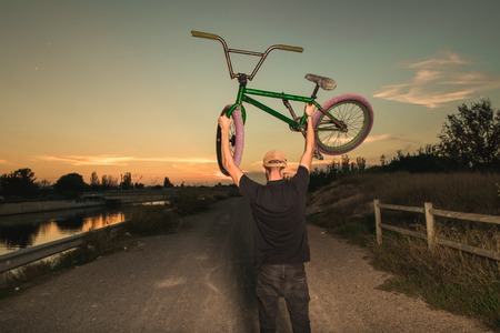 Portrait of a young man with a bmx bicycle. BMX rider