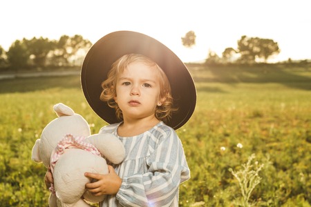 Portrait of a beautiful little girl with a hat. Kids with hatsの写真素材