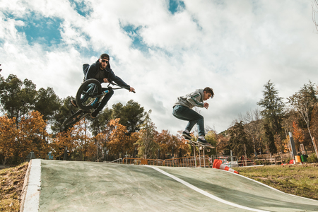 Young skateboarders and bmx bikes. Young people practicing sports in the cityの写真素材