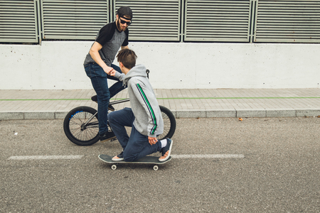 Young people with skateboard and bmx bike. Extreme urban sportsの写真素材