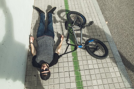 Young man with a bmx bike on the street. BMX riderの写真素材