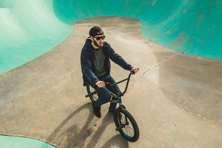 Boy riding and jumping bmx bike in a park.Extreme urban sportsの写真素材