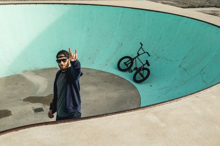 Young man with his bmx bike. Extreme urban sports concept