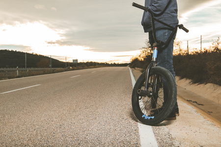Young man with a bmx bike. BMX rider doing tricks. Extreme urban sports conceptの写真素材