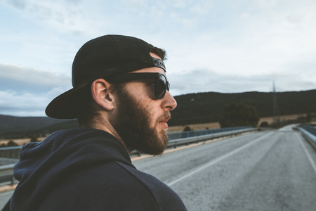 Portrait of a guy with cap and sunglasses. Photo style social networks