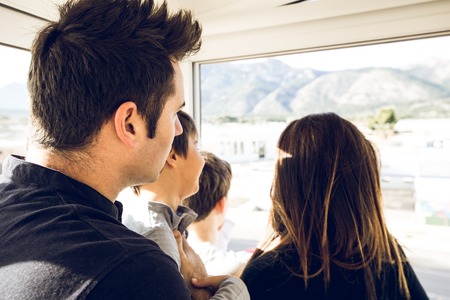 A family looking out the window of the house. Concept of a happy and united family at homeの写真素材