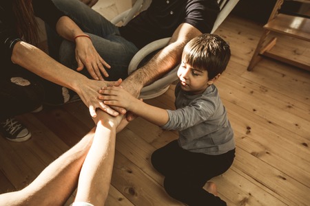 Portrait of a happy family with joined hands. Concept of a fun and united familyの写真素材