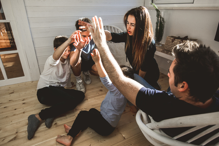 A happy family at home with fun and positive expression. Concept of love and affection of a united familyの写真素材