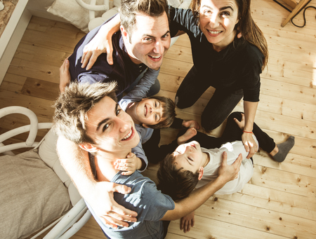 Portrait of a family hugging and smiling at home. Lifestyle of a happy and united family