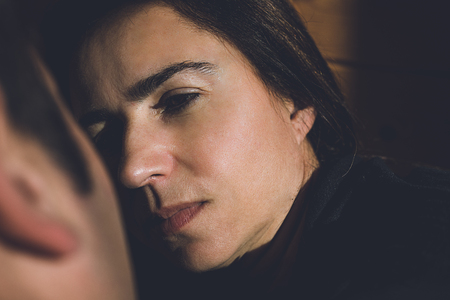Portrait of a happy young couple looking into each other's eyes. Close-up of a man and a woman in love looking into each other's eyes in a romantic way.Concept of love, happiness and romanticismの写真素材