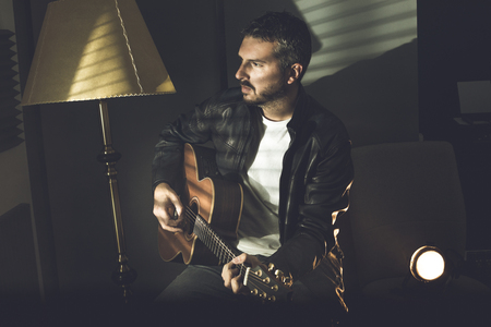 Guy handsome playing guitar. Guitarist playing. Concept of musician