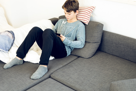 Child watching a tablet at home. Boy looking at a tablet.Concept technology childrenの写真素材