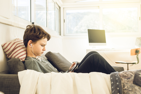 Child watching a tablet at home. Boy looking at a tablet.Concept technology childrenの写真素材