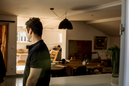 Portrait of a man in profile at home.Guy with his back to the house.の写真素材