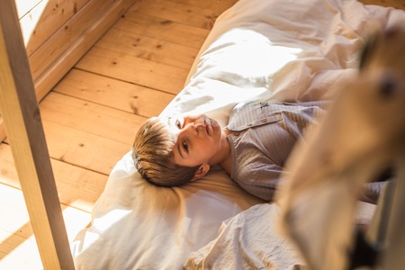 Close-up of a child taking a nap. Kid lying in bed in his room. Child sleepingの写真素材