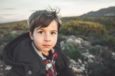 Portrait of a little boy with funny expression and smiling in the countryside. Happy child Conceptの写真素材