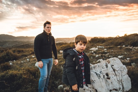 Father with his son walking in the countryside. Dad and child together