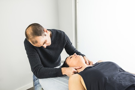 Physiotherapist working on massaging a patient in the neck. Concept of physiotherapy and...