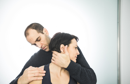 Close-up of a physiotherapist massaging the neck of a beautiful young woman. Concept physiotherapy and healthの写真素材