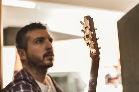 Portrait of a handsome man with a Spanish guitar. Guitarist Concept