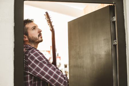 Portrait of a handsome man with a Spanish guitar. Guitarist Conceptの写真素材