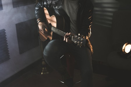 Dramatic portrait of a man playing a guitar. Guitarist conceptの写真素材
