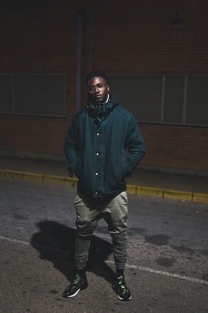 Portrait of young black man and handsome confident and trendy in the streetの写真素材