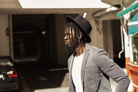Portrait Young African American man dressed in style on the city streetの写真素材