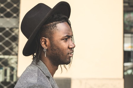 Portrait Young African American man dressed in style on the city street