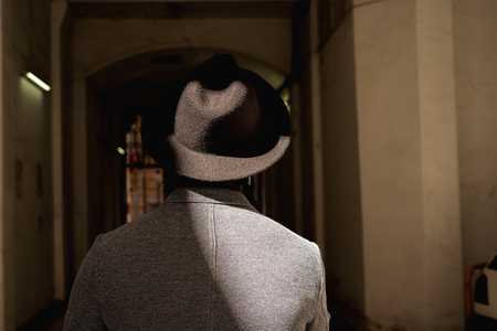 Man with a hat with his back to the streetの写真素材