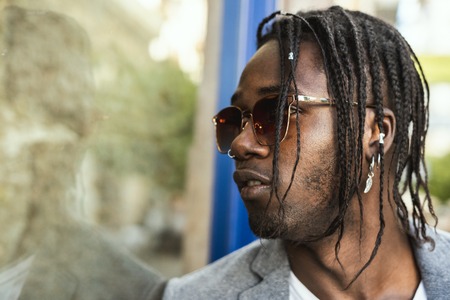 Portrait Handsome African American man elegant profile with sunglasses. Concept of black man with styleの写真素材