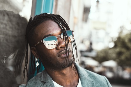 Portrait Handsome African American man elegant profile with sunglasses. Concept of black man with styleの写真素材