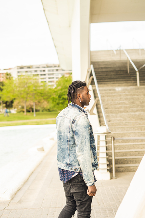 Outdoor portrait of a handsome young African with serious expressionの写真素材