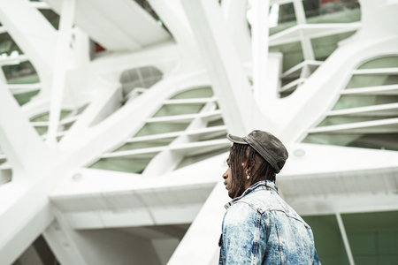Guy handsome dressed in style and modern with a cap streetの写真素材