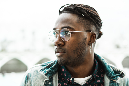 Portrait of a handsome African hipster man with modern eyewear. Lifestyle concept