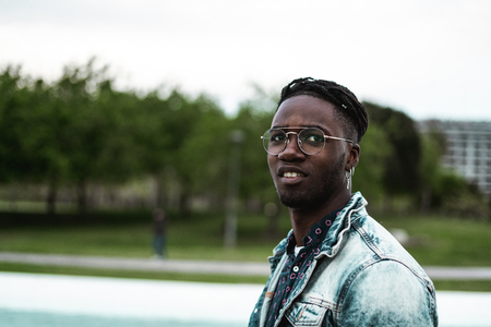Portrait of handsome African American man smiling in the street with modern glasses. Happy and Positive Person Conceptの写真素材