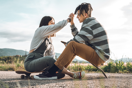Young people skateboarding and having fun. Skateboard coupleの写真素材