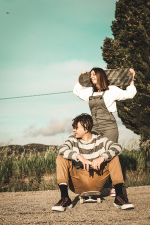 Young couple riding skateboarding having fun. Modern skateboarders millennial peopleの写真素材