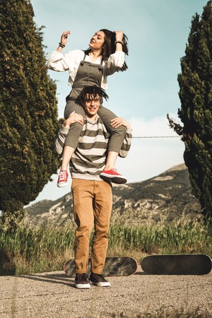 Portrait of a couple with happy and fun skateboards. People riding a skateboardの写真素材