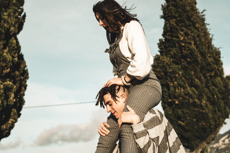 Portrait of a young couple of happy and funny lovers outdoors. Millennial peopleの写真素材