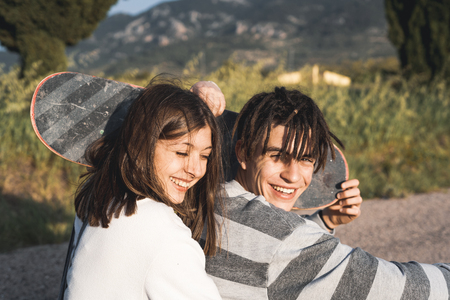 Portrait of a couple with happy and fun skateboards. People riding a skateboardの写真素材